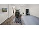 Clean bedroom with a bed, gaming desk, wall-mounted TV, and view into a home's hallway at 4085 37Th N Ave, St Petersburg, FL 33713