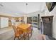 Open floor plan with a dining table and fireplace adjacent to a kitchen and living room at 4085 37Th N Ave, St Petersburg, FL 33713