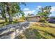 Front view of brick home with a driveway and lawn. Car parked on side at 4085 37Th N Ave, St Petersburg, FL 33713