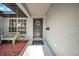 Inviting front entrance with a black door, complemented by a decorative wreath and a cozy bench at 4085 37Th N Ave, St Petersburg, FL 33713