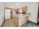 Well-lit kitchen featuring light wood cabinets, white appliances, and a convenient breakfast bar at 4085 37Th N Ave, St Petersburg, FL 33713