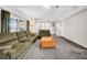 Spacious living room with plush carpeting, comfortable seating, and bright, neutral walls at 4085 37Th N Ave, St Petersburg, FL 33713