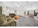 Open-concept living room with plush carpeting, comfortable seating, adjoining dining area, and neutral walls at 4085 37Th N Ave, St Petersburg, FL 33713