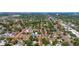 Expansive aerial view showcasing the neighborhood, highlighting the yellow house with solar panels at 4517 2Nd S Ave, St Petersburg, FL 33711