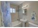 Updated bathroom featuring tiled walls, decorative mirror, updated vanity and hardware at 4517 2Nd S Ave, St Petersburg, FL 33711