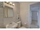 Well-lit bathroom features a bright vanity, decorative backsplash, and a classic white toilet at 4517 2Nd S Ave, St Petersburg, FL 33711