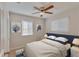 Bedroom with tiled floor, ceiling fan and two windows with neutral colored walls at 4517 2Nd S Ave, St Petersburg, FL 33711