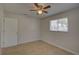 Comfortable bedroom with tiled floor, ceiling fan and a sun-lit window at 4517 2Nd S Ave, St Petersburg, FL 33711