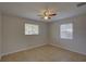 Bright bedroom with tiled floor, a ceiling fan and two windows at 4517 2Nd S Ave, St Petersburg, FL 33711