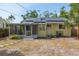 Charming home exterior with solar panels, screened porch, and well-maintained landscaping at 4517 2Nd S Ave, St Petersburg, FL 33711
