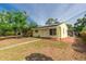 Quaint yellow house showcasing a screened porch and tidy landscaping at 4517 2Nd S Ave, St Petersburg, FL 33711