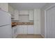Well-lit kitchen with white cabinets, granite countertops, and stainless-steel appliances at 4517 2Nd S Ave, St Petersburg, FL 33711