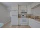 Well-lit kitchen with white cabinets, granite countertops, and stainless-steel appliances at 4517 2Nd S Ave, St Petersburg, FL 33711