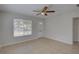 Bright living room with neutral walls, tile flooring, ceiling fan, and plenty of natural light at 4517 2Nd S Ave, St Petersburg, FL 33711