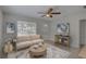 Bright living room features neutral paint, decor, large windows, ceiling fan, and tile floor at 4517 2Nd S Ave, St Petersburg, FL 33711