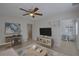 Bright living room features neutral paint, decor, large windows, ceiling fan, and tile floor at 4517 2Nd S Ave, St Petersburg, FL 33711