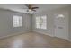 Bright living room features neutral paint, large windows, ceiling fan, and tile floor at 4517 2Nd S Ave, St Petersburg, FL 33711