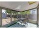 Cozy screened patio with a table and chairs, perfect for outdoor dining and relaxation at 4517 2Nd S Ave, St Petersburg, FL 33711