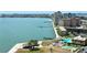 An aerial view of a coastal community with waterfront buildings, a pier, and a pool area at 4900 Brittany S Dr # 1810, St Petersburg, FL 33715