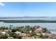 Aerial view showcasing waterfront homes, lush landscaping, and stunning water views with a distant bridge at 4900 Brittany S Dr # 1810, St Petersburg, FL 33715