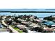 An aerial view of a residential neighborhood near the water, featuring lush vegetation and diverse architecture at 4900 Brittany S Dr # 1810, St Petersburg, FL 33715