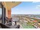 Relax on this balcony featuring cozy seating and scenic views of the water and surrounding neighborhood at 4900 Brittany S Dr # 1810, St Petersburg, FL 33715