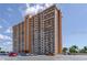 Image of a luxury high-rise condominium building with a beige facade and private balconies for each unit at 4900 Brittany S Dr # 1810, St Petersburg, FL 33715
