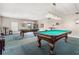This game room features two billiard tables with overhead lighting, creating an ideal space for recreation and entertainment at 4900 Brittany S Dr # 1810, St Petersburg, FL 33715