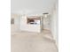 A bright living room with carpet, and a partial view of the kitchen area at 4900 Brittany S Dr # 1810, St Petersburg, FL 33715