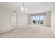 A living room with carpet flooring and a sliding glass door to a balcony with a water view at 4900 Brittany S Dr # 1810, St Petersburg, FL 33715