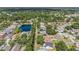 Aerial view of neighborhood featuring lush greenery, nearby lake, and well-maintained homes at 4914 Country Hills Dr, Tampa, FL 33624