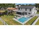 Aerial view of a backyard with a swimming pool and an enclosed patio at 4914 Country Hills Dr, Tampa, FL 33624