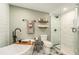 Modern bathroom featuring a sleek bathtub, glass shower, elegant fixtures, and patterned tile floor at 4914 Country Hills Dr, Tampa, FL 33624