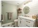 Well-lit bathroom with a marble vanity, round mirror, modern fixtures, and eye-catching tile floor at 4914 Country Hills Dr, Tampa, FL 33624