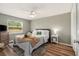 Bright bedroom with a comfortable bed, wood floors, a ceiling fan, and natural light from the window at 4914 Country Hills Dr, Tampa, FL 33624