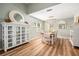 Bright dining area with wood floors, decorative mirrors, and modern light fixture at 4914 Country Hills Dr, Tampa, FL 33624