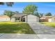 Inviting two-story home featuring a well-manicured lawn and an attached two-car garage at 4914 Country Hills Dr, Tampa, FL 33624
