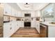 Updated kitchen featuring white cabinets, stainless steel appliances, and modern countertops at 4914 Country Hills Dr, Tampa, FL 33624