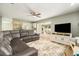 Spacious living room featuring an entertainment center and access to the lanai at 4914 Country Hills Dr, Tampa, FL 33624