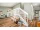 Bright open-concept living space with wood floors and staircase at 4914 Country Hills Dr, Tampa, FL 33624
