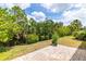 Expansive backyard with lush greenery and a paved patio, perfect for outdoor entertaining at 5048 Inshore Landing Dr, Apollo Beach, FL 33572