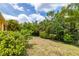 Lush backyard featuring mature trees and landscaping, offering a private outdoor space at 5048 Inshore Landing Dr, Apollo Beach, FL 33572
