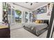 Bedroom featuring shuttered windows, wall decor, and a comfortable gray bed at 5048 Inshore Landing Dr, Apollo Beach, FL 33572