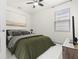 Well-lit bedroom with a cozy bed, modern artwork, and a large window at 5048 Inshore Landing Dr, Apollo Beach, FL 33572