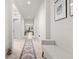 Bright hallway with tile flooring, neutral paint, recessed lighting, and arched doorways at 5048 Inshore Landing Dr, Apollo Beach, FL 33572