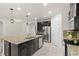 Spacious kitchen with stainless steel appliances, dark cabinetry, granite countertops, and an island at 5048 Inshore Landing Dr, Apollo Beach, FL 33572