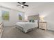 Serene main bedroom with plush carpet, neutral walls, and a tufted headboard with side tables at 5048 Inshore Landing Dr, Apollo Beach, FL 33572