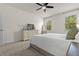 Bright main bedroom features neutral colors, a ceiling fan, and dresser with a TV at 5048 Inshore Landing Dr, Apollo Beach, FL 33572