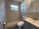 Updated bathroom featuring a walk-in shower, gray vanity and modern fixtures at 5660 86Th Ave, Pinellas Park, FL 33782