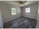 This bedroom is filled with natural light and features wood-look flooring and a ceiling fan at 5660 86Th Ave, Pinellas Park, FL 33782